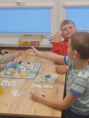 Grupa uczni&oacute;w klasy 4b podczas gry w Monopoly 